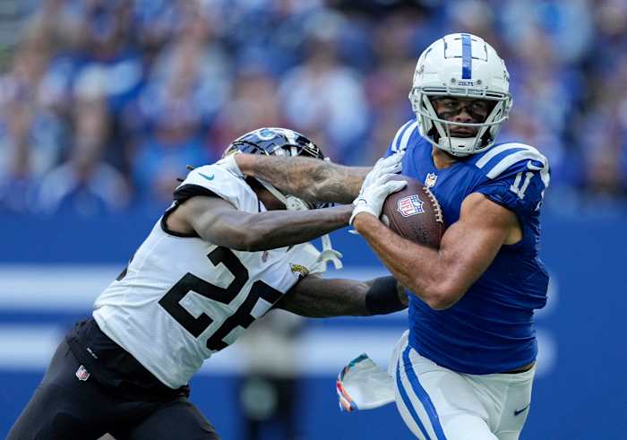 Oct 16, 2022; Indianapolis, Indiana, USA; Indianapolis Colts wide receiver Michael Pittman Jr. (11) pushes off of Jacksonville Jaguars cornerback Shaquill Griffin (26) as he runs with the ball during the first half at Lucas Oil Stadium.
